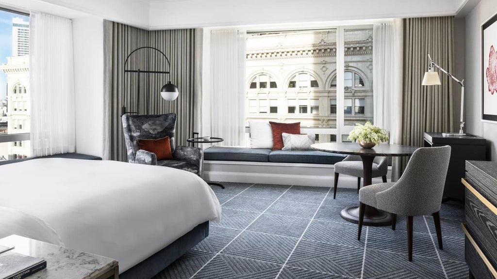 Luxurious deluxe room at Four Seasons Hotel in San Francisco, featuring elegant contemporary design with city skyline views and plush king-sized bed