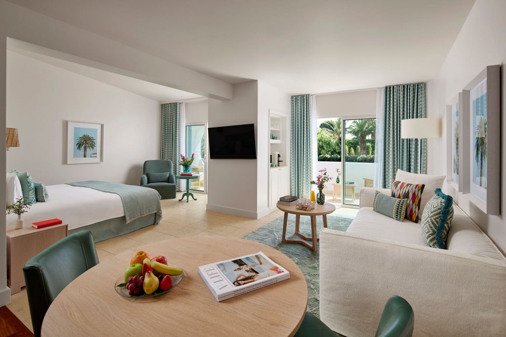 Elegant Deluxe Ocean View room at Vila Vita Parc Resort, featuring contemporary Portuguese design with panoramic azure coastline and modern luxurious furnishings