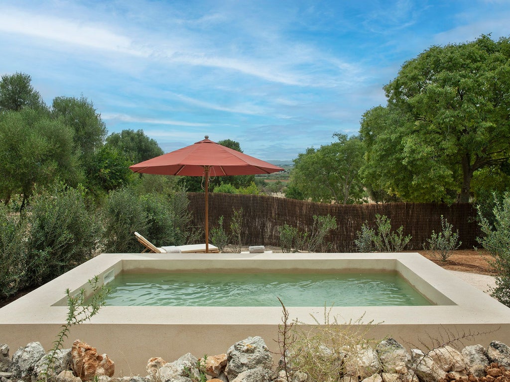 Luxurious private pool suite at Scenset Lodge in Mallorca, Spain, with modern design, sun-drenched terrace, and pristine turquoise swimming pool.