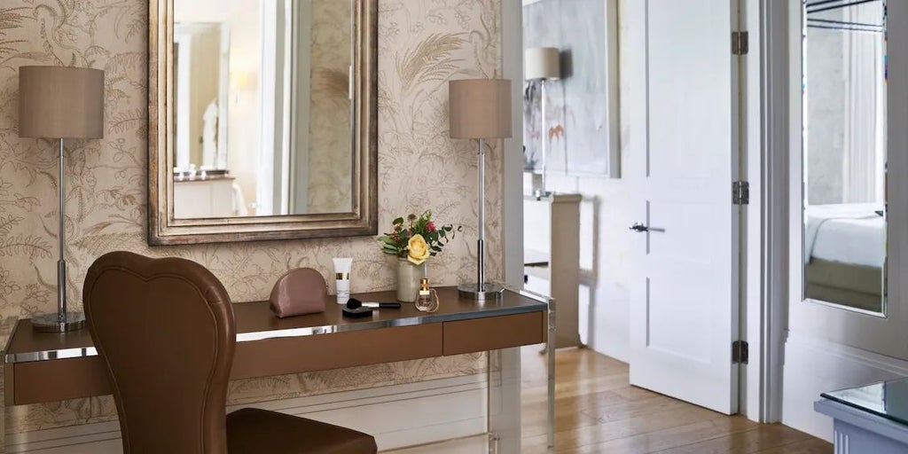 Luxurious cream and gold premium suite at Scenset Park, featuring elegant four-poster bed, ornate fireplace, and plush traditional British decor