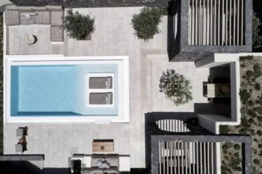 Cliffside infinity pool overlooking Santorini's caldera at sunset, with minimalist white architecture and private luxury cabanas