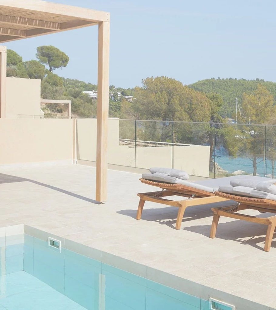 Luxurious junior suite with private pool overlooking azure waters, wooden deck, and modern minimalist design at ELIVI resort in Skiathos, Greece