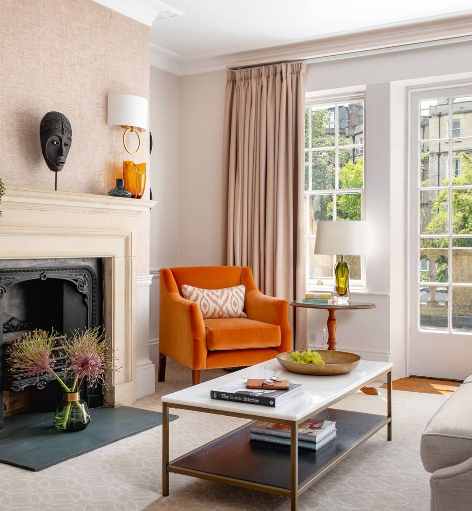 Elegant Deluxe Suite at Royal Crescent Hotel & Spa, featuring opulent period furnishings, soft neutral tones, and sweeping architectural windows overlooking historic scenset landscape