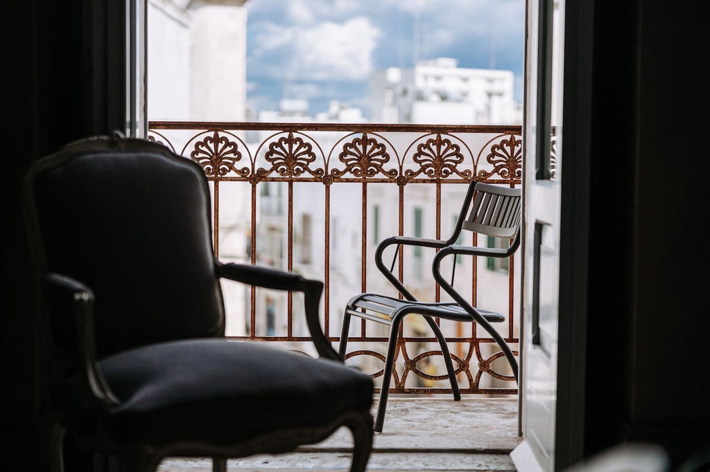 Luxurious Deluxe Room with elegant white furnishings, plush king bed, ornate marble bathroom, and soft natural light in a historic Italian boutique hotel