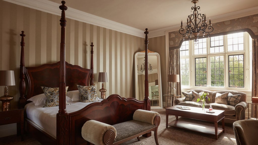 Luxurious state room at Bovey Castle Hotel and Spa, featuring elegant period furnishings, ornate four-poster bed, and refined traditional British decor