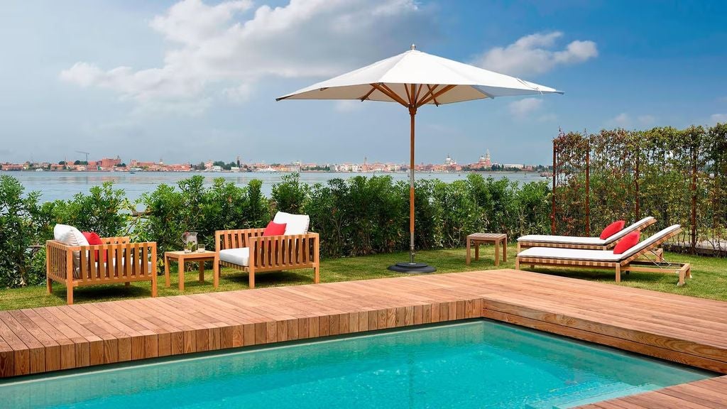 Elegant pool suite at JW Marriott Venice featuring private terrace, plunge pool, luxurious loungers, and panoramic lagoon views