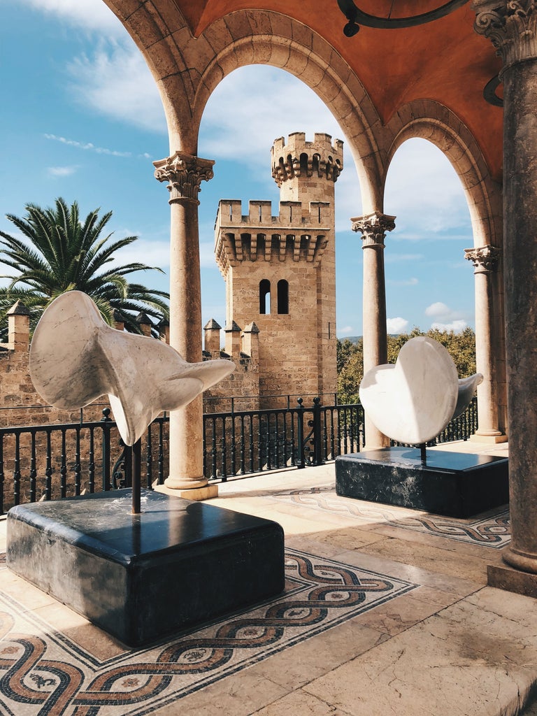 Elegant historic street in Palma de Mallorca with sunlit stone architecture, vibrant Mediterranean colors, and stylish pedestrians exploring charming Old Town landmarks