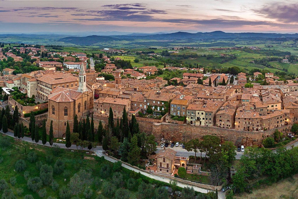 Elegant stone villa nestled in Tuscany's rolling hills, surrounded by lush vineyards and cypress trees at golden sunset light