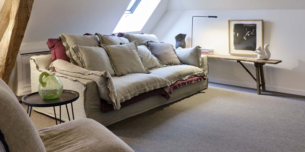 Luxurious modern bedroom at Château de la Resle in Montigny, France, with minimalist design, white linens, and elegant contemporary furnishings.