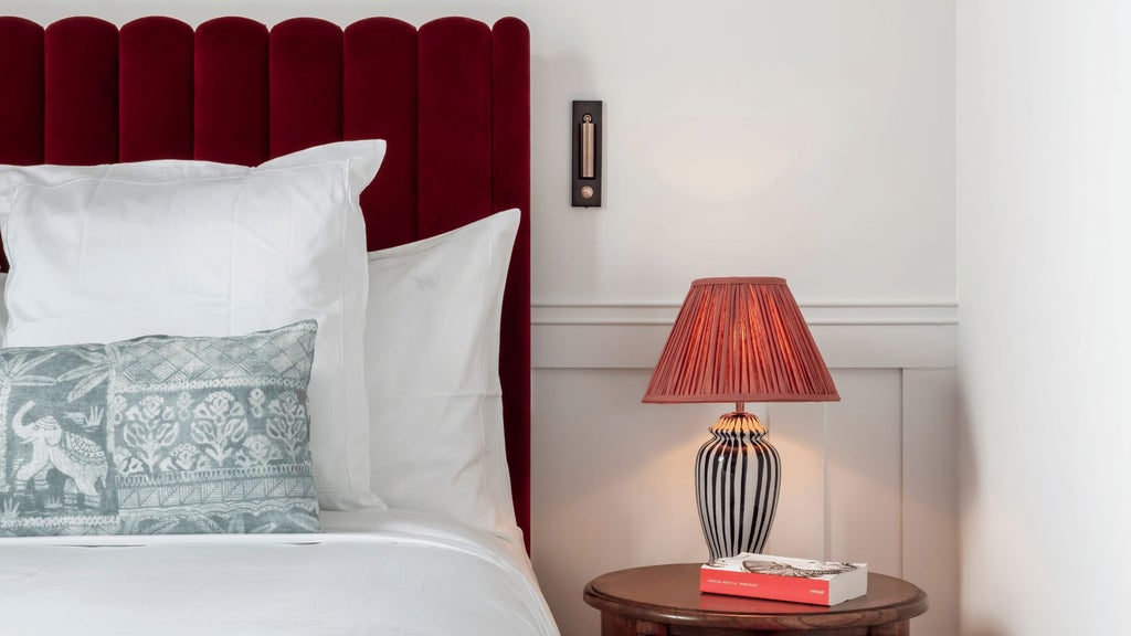 Luxurious French terrace room with elegant furnishings, soft neutral tones, plush bedding, and expansive vineyard views at a sophisticated boutique hotel