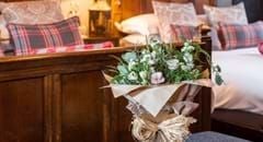 Classic twin hotel room at The Lygon Arms with elegant traditional decor, wooden furnishings, crisp white linens, and subtle British countryside charm