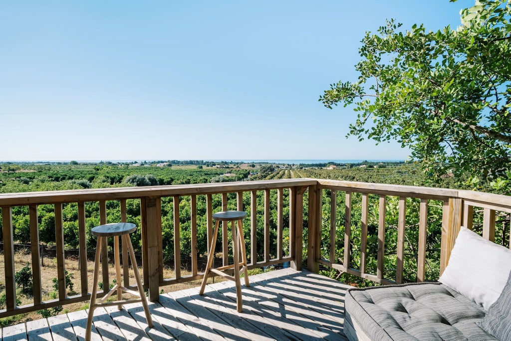 Luxurious treehouse suite with wooden interiors, large windows showcasing lush Portuguese forest, minimalist design, and elegant rustic charm at elevated level