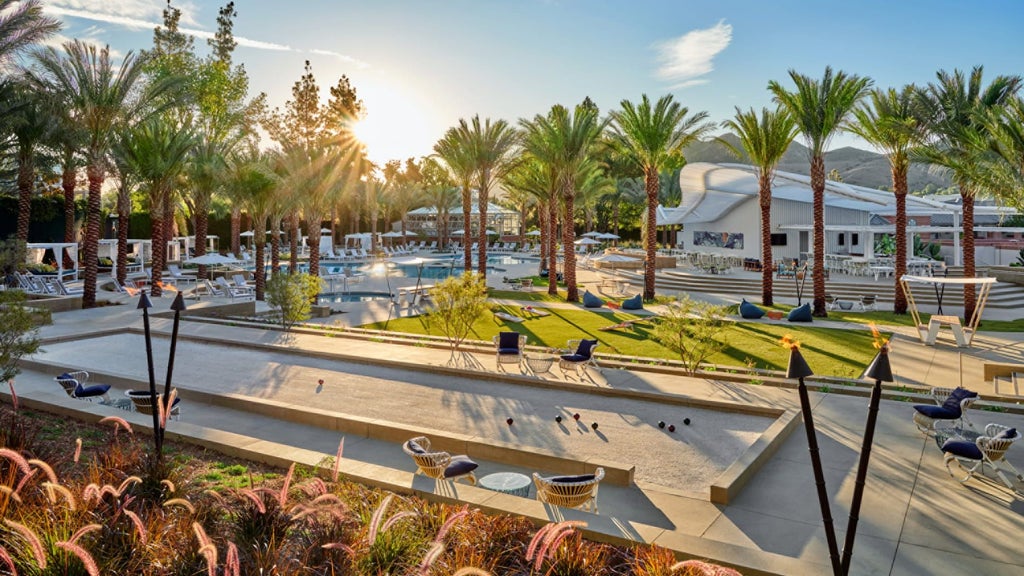 Luxurious poolside view of Four Seasons resort in Westlake Village, California, with elegant architecture, palm trees, and pristine outdoor lounge area