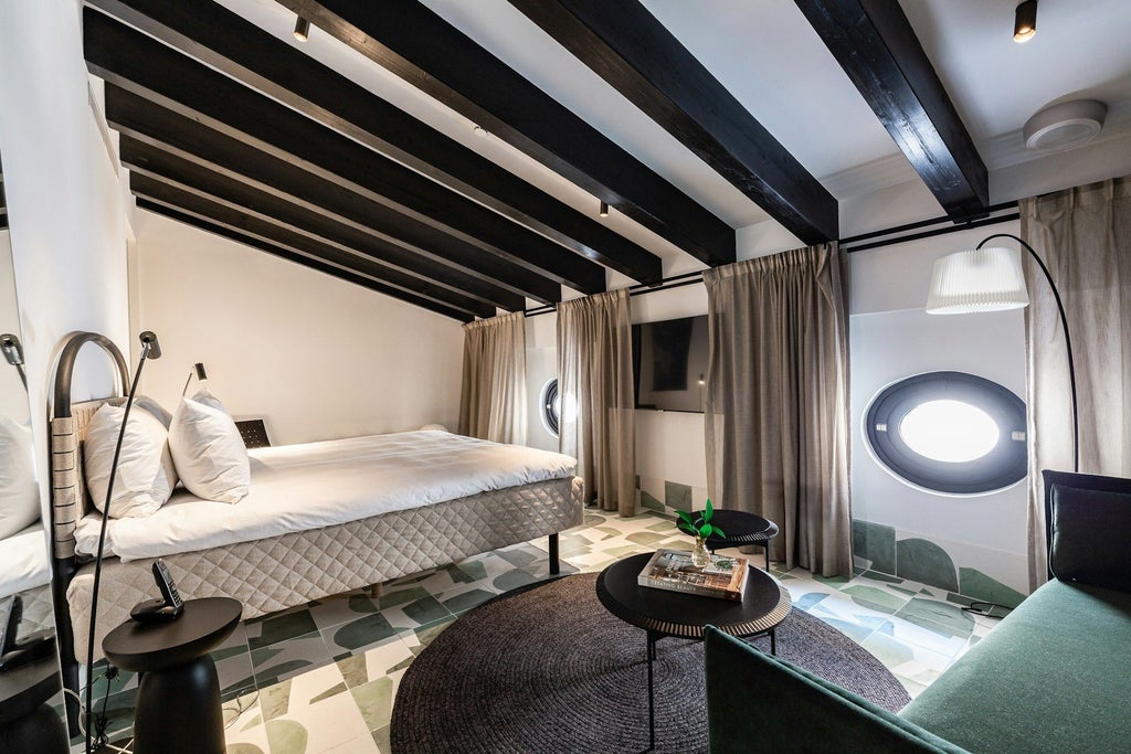 Elegant attic hotel room with white walls, wooden beams, plush white bedding, and minimalist Nordic-inspired design in historic Spanish hotel