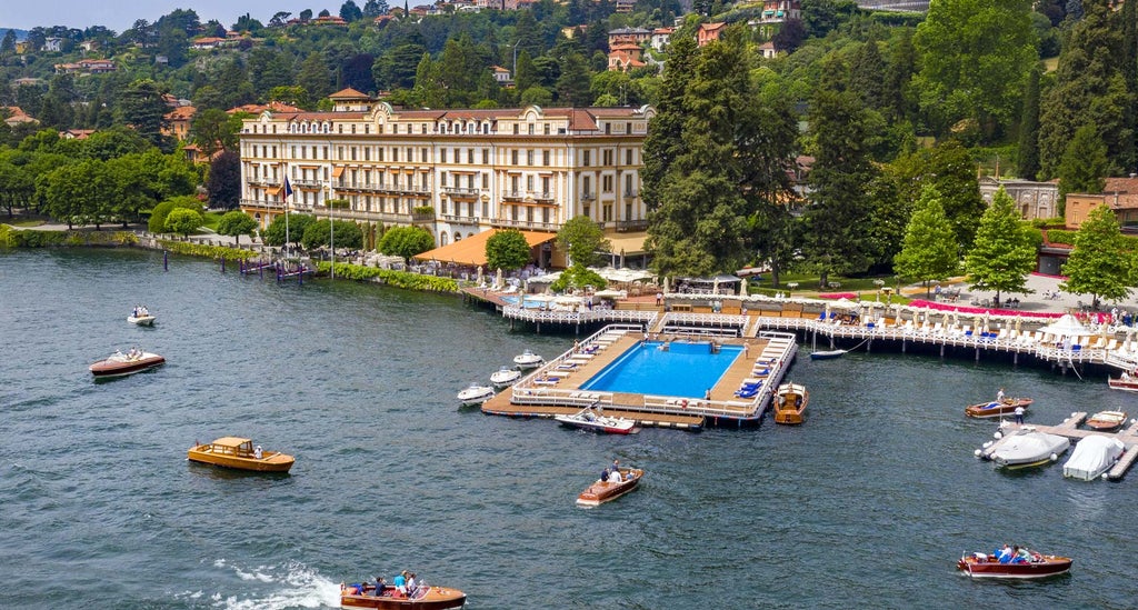 Opulent Italian Renaissance villa on Lake Como features manicured gardens, grand fountains and classical architecture lit at dusk