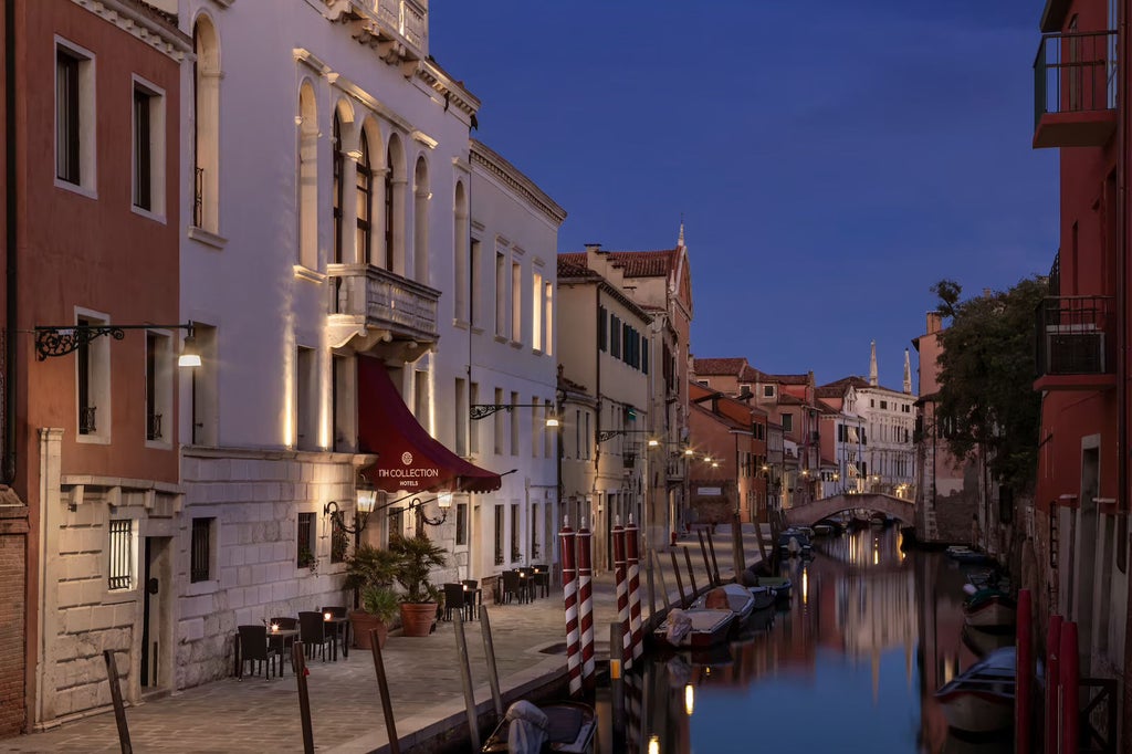 Historic Venetian palazzo hotel with private garden, Murano chandeliers, and canal frontage in quiet residential district