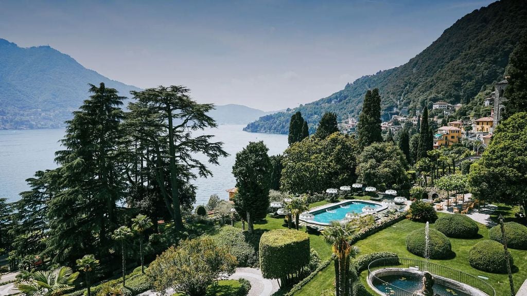 Historic Italian villa-turned-luxury hotel Passalacqua sits on Lake Como's edge with manicured terraced gardens, classical facade and lakeside views