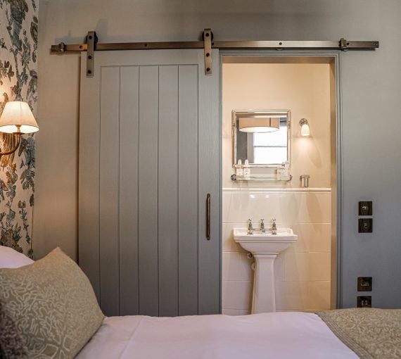 Elegant classic king hotel room with modern minimalist decor, soft neutral color palette, plush bedding, and sophisticated lighting in Bath, United Kingdom