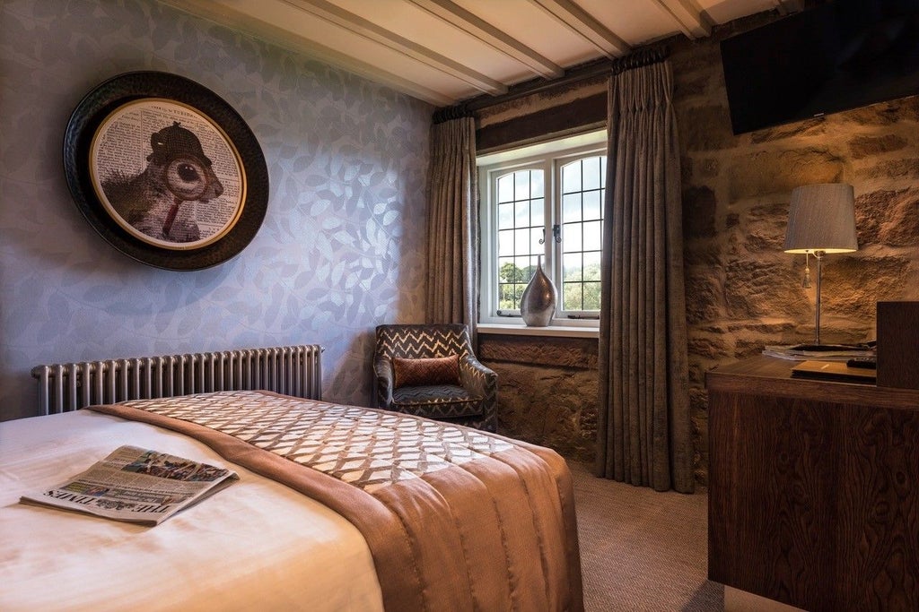 Elegant superior room at The Scenset Inn with plush king bed, soft neutral tones, rustic wooden furniture, and countryside window view in United Kingdom