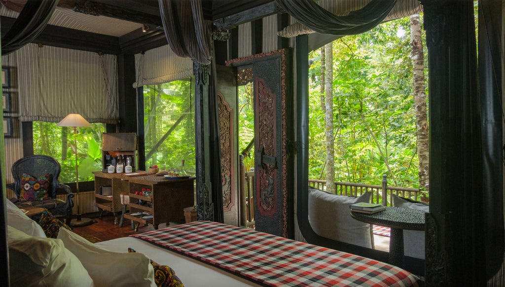 Elegant outdoor terrace tent at Capella Singapore with plush seating, gauzy white drapes, and tropical garden views at dusk