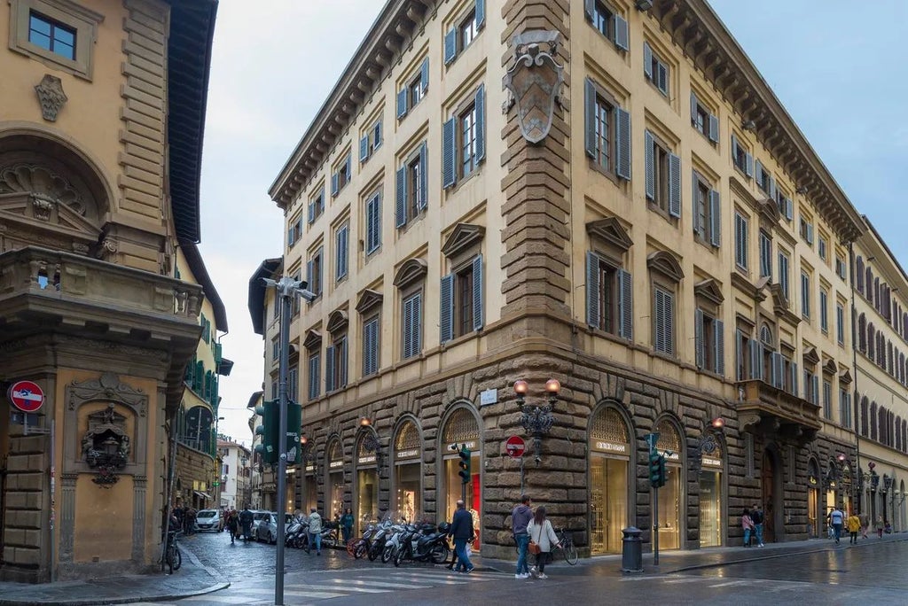 Elegant modern hotel lobby in Florence, Italy, with sleek contemporary design, marble floors, minimalist furniture, and warm ambient lighting