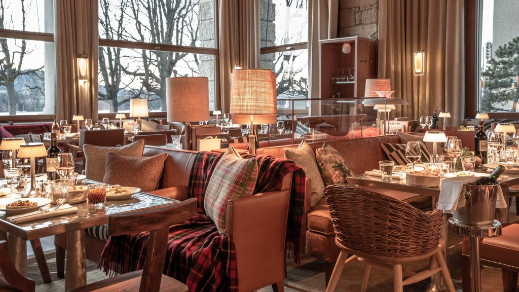 Five-star lakeside hotel in Zurich with classic belle époque architecture, featuring elegant white facade and ornate balconies overlooking Lake Zurich