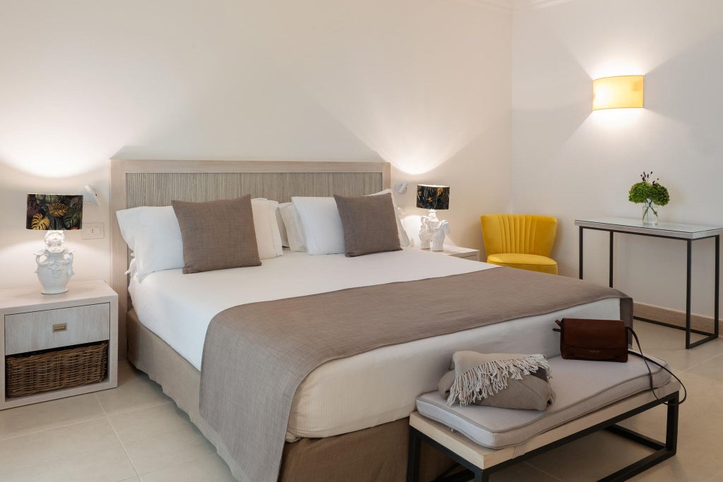 Luxurious white-themed superior plus hotel room with minimalist design, crisp linens, and elegant coastal Italian decor at Canne Bianche Lifestyle Hotel