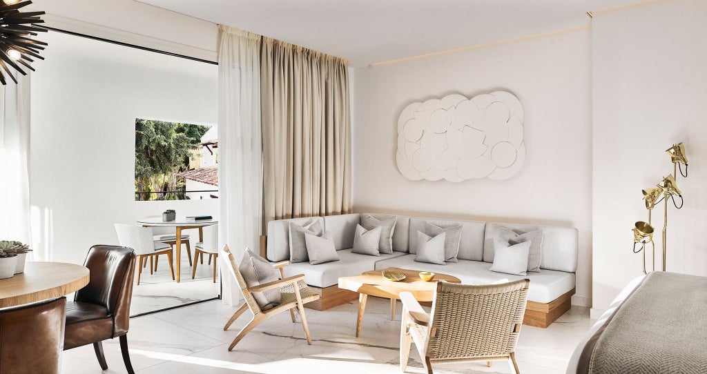 Luxury Nobu Hotel Marbella suite with sleek white decor, panoramic ocean view, minimalist design, and contemporary Mediterranean styling