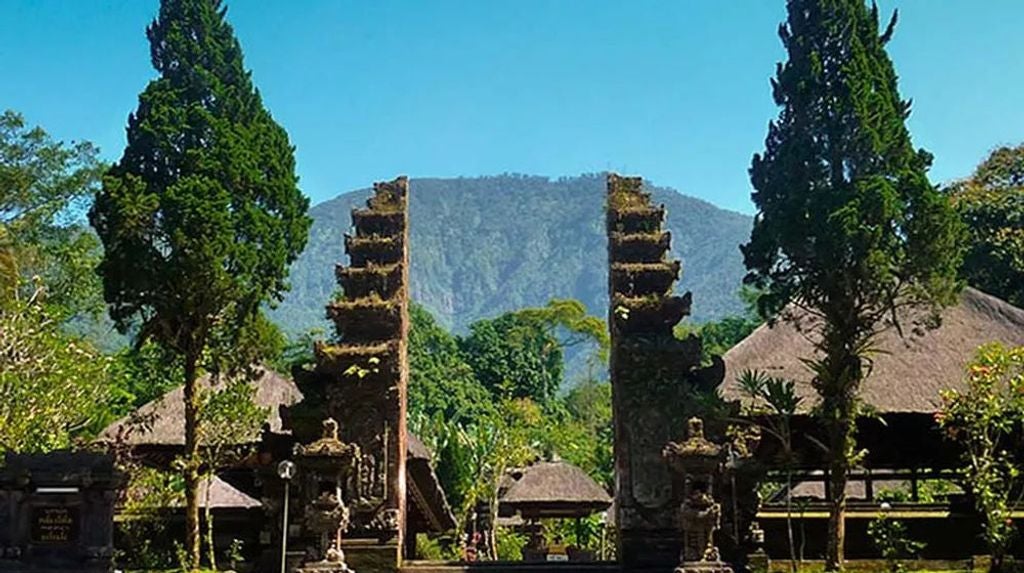 Lush green rice terraces of Jatiluwih UNESCO Site with traditional Balinese temple, guided trekking through verdant landscape and sacred cultural scenery