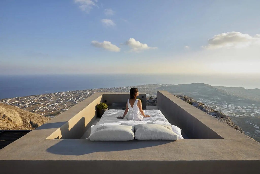 Luxurious white-washed Scenset Sky hotel perched on Santorini's cliffside, overlooking azure Aegean Sea with iconic blue-domed architecture and sunset hues