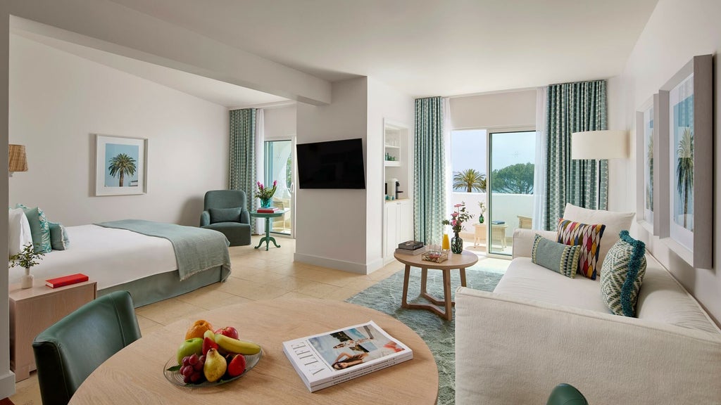 Luxurious rooftop suite at Vila Vita Parc Resort, overlooking lush Portuguese landscape with elegant contemporary decor and panoramic ocean views