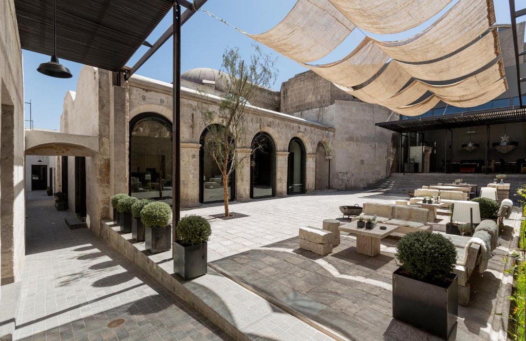 Elegant colonial boutique hotel in Arequipa with white volcanic stone walls, arched doorways and traditional Spanish-style courtyards