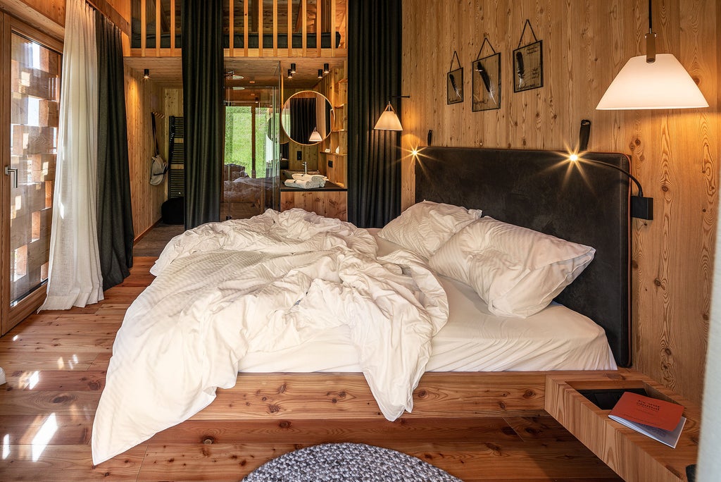 Historic alpine lodge with modern wooden cabins nestled in snowy Dolomites mountains, featuring minimalist architecture and panoramic views