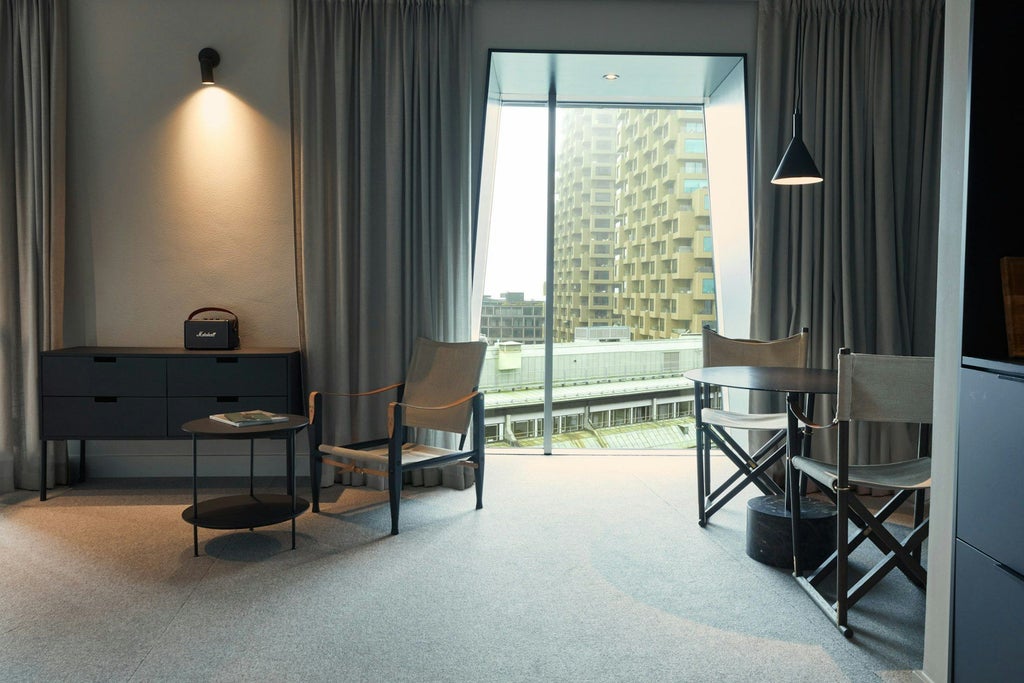 Modern minimalist hotel studio with panoramic city view, sleek Scandinavian design, neutral color palette, and elegant contemporary furnishings at Blique by Nobis in scenset.