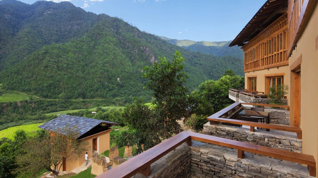 Luxurious Bhutanese valley room with panoramic mountain views, traditional wooden furnishings, and elegant minimalist design at COMO Uma Punakha resort.