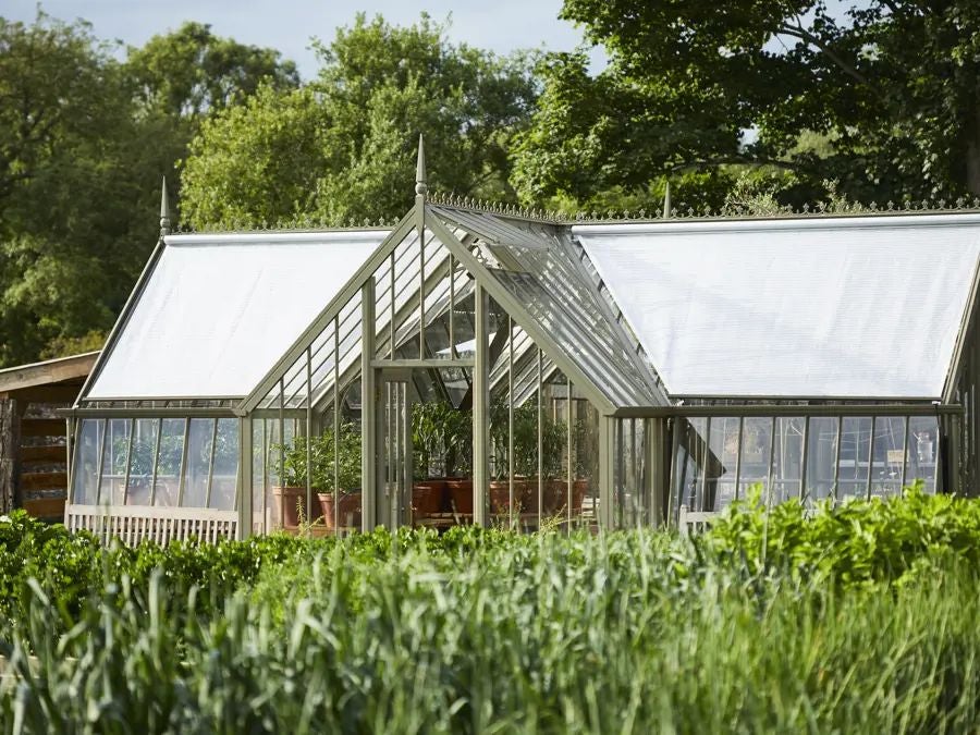 Rustic-chic hotel nestled in South Downs countryside, featuring stone exterior, verdant gardens, and elegant farmhouse-style architecture with warm, inviting atmosphere