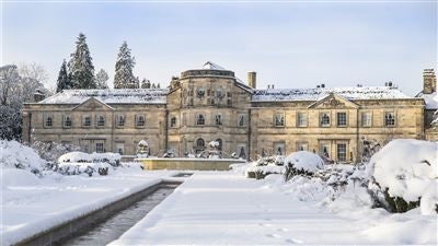 Elegant neo-Georgian manor hotel with manicured gardens, nestled in Yorkshire countryside, showcasing luxurious architectural details and pristine landscaping