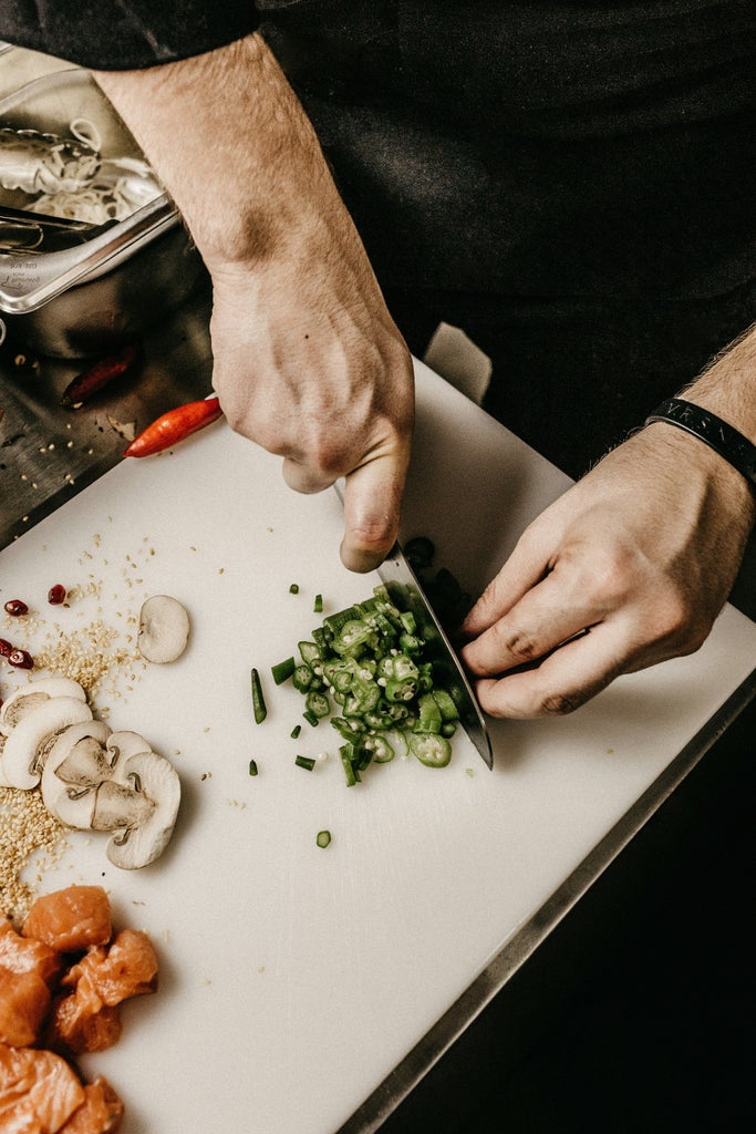 Croatian chef in modern kitchen demonstrates traditional pastry making, surrounded by fresh ingredients and copper cookware