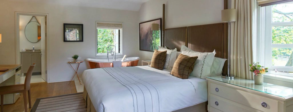 Luxurious Coworth Park Cottage Executive Suite with elegant modern decor, plush furnishings, soft neutral tones, and expansive natural lighting