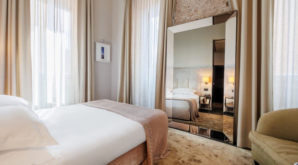 Elegant triple junior suite at D.O.M Hotel with soft neutral tones, luxurious modern furnishings, plush bedding, and sophisticated Italian design aesthetic