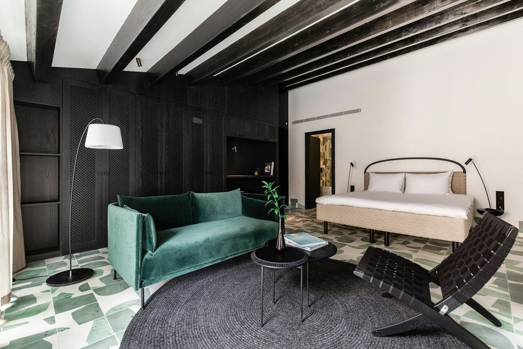 Elegant junior suite with modern Nordic design, white marble bathroom, plush bedding, and minimalist decor in a boutique hotel setting at Concepció by Nobis in Spain