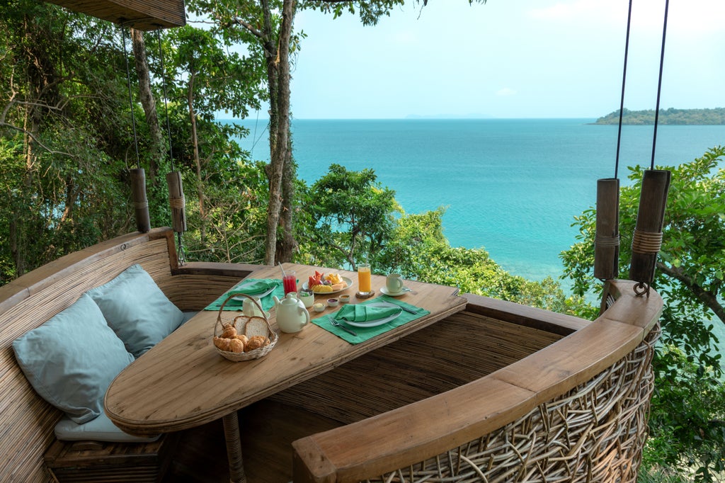 Luxurious oceanfront villa at Soneva Kiri with private infinity pool, wooden sundecks, and tropical palm trees overlooking turquoise waters