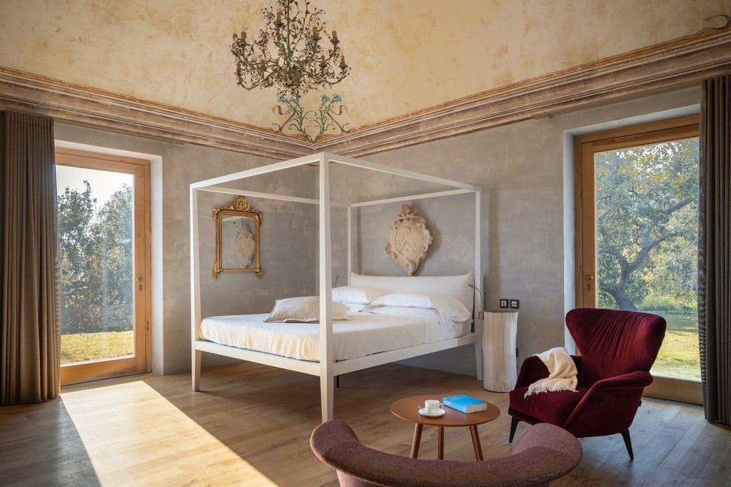 Elegant Sicilian pool suite with stone walls, contemporary furnishings, panoramic vineyard views, and Mount Etna backdrop at Monaci delle Terre Nere