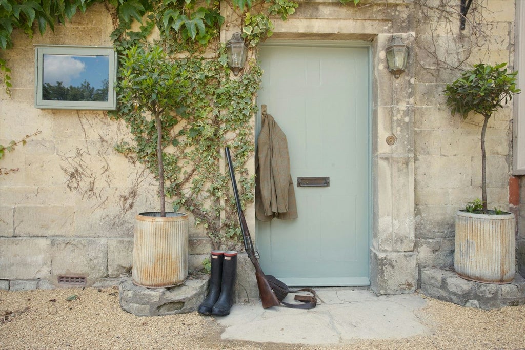 Charming stone country hotel nestled in lush Wiltshire landscape, featuring elegant facade, manicured gardens, and traditional British architectural style