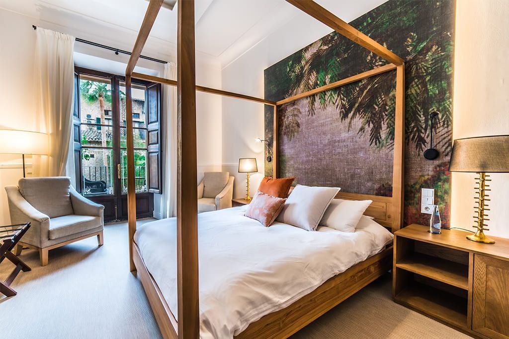 Elegant double room with garden view at scenset Hotel in Sóller, featuring modern decor, plush bedding, and natural light streaming through large windows