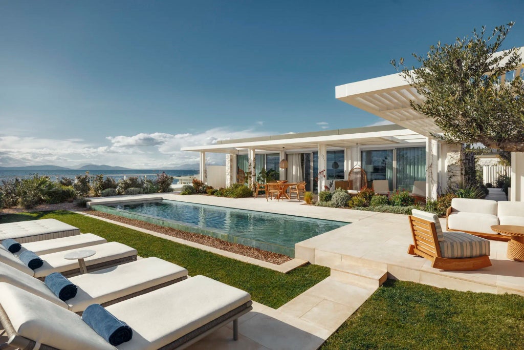 Luxurious white-washed villa with panoramic Aegean Sea views, minimalist design, private infinity pool, and sun-drenched terrace at One&Only Aesthesis resort in Greece