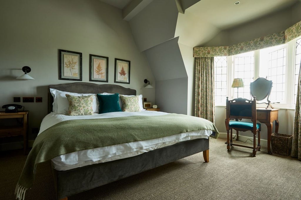 Coastal chic hotel room with rustic wooden furniture, plush white bedding, and large windows overlooking sandy shoreline and azure waters