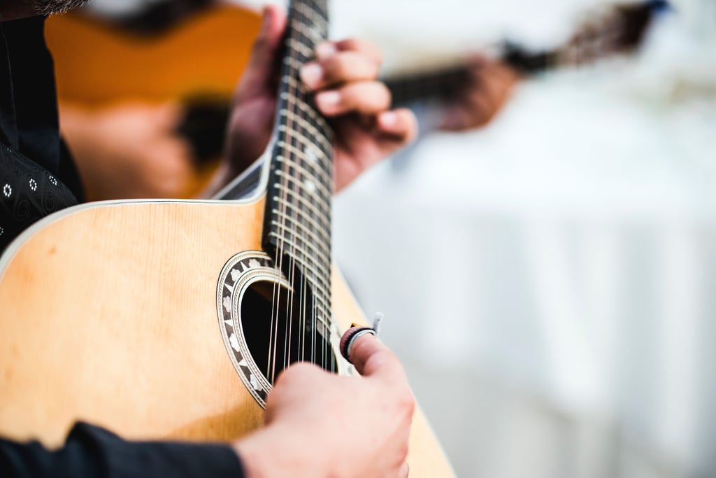 Passionate fado musician in elegant attire performs under warm golden lights, Portuguese guitar gleaming, intimate Lisbon venue creating soulful, nostalgic atmosphere