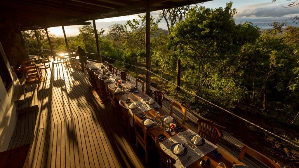 Luxurious eco-lodge nestled in lush Ecuadorian landscape, featuring modern safari-style tent with panoramic views of rugged Galapagos terrain.