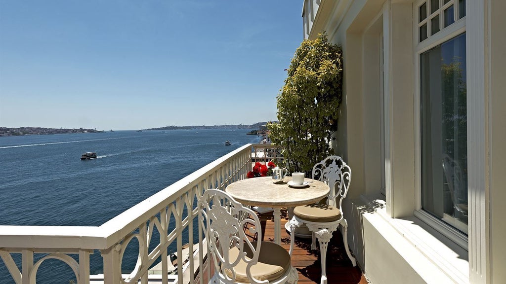 Luxurious penthouse suite overlooking Bosphorus, featuring elegant modern decor, floor-to-ceiling windows, and panoramic Istanbul skyline views